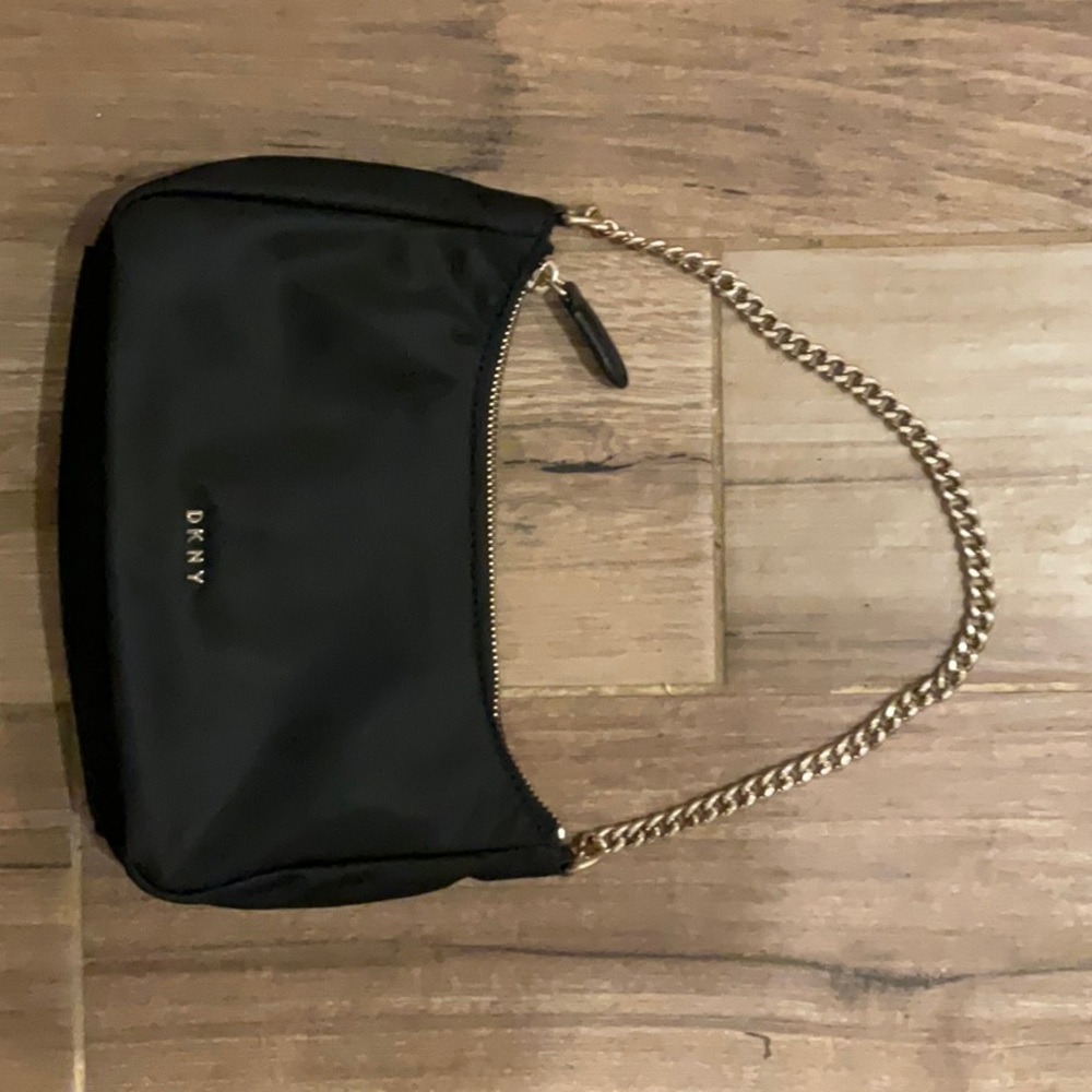 Small handbag measuring approximately 9 in by 5 in